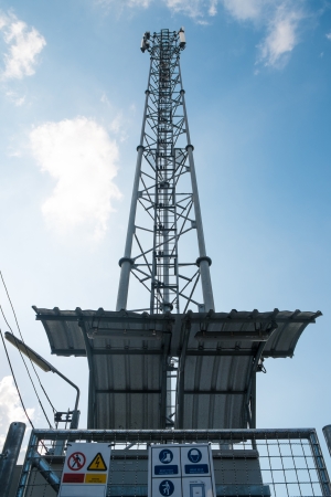 Grey telecommunication tower with the blue skyの写真素材