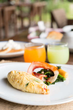 Omelette with salad, orange juice and guava juice  Breakfast set tastyの写真素材