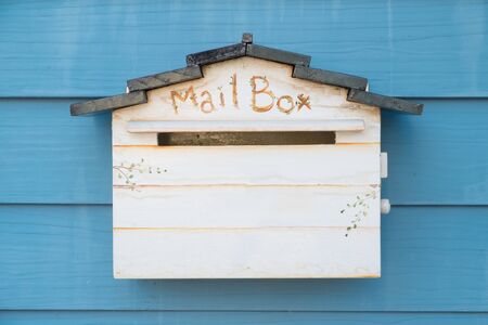 Vintage Style Mailbox on blue wall with space for your textの写真素材