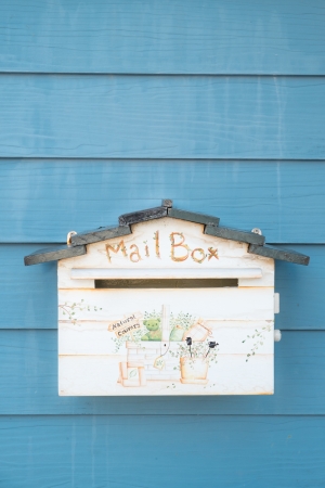 Vintage Style Mailbox on blue wallの写真素材