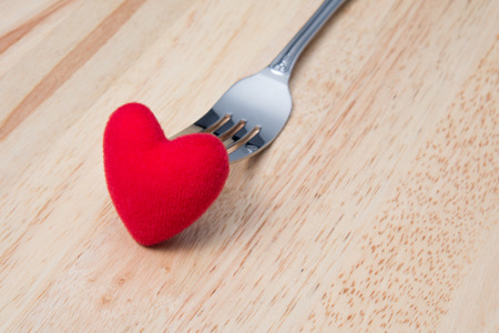 Red Heart with Fork on Wooden Table for Valentineの写真素材