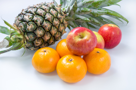 Fresh Apple Orange Pineapple Fruit on white tableの写真素材