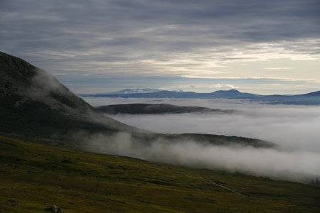 Low clouds over the forests and mountain peaks, early morning sunrise in Idre Sweden Northern Europeの写真素材