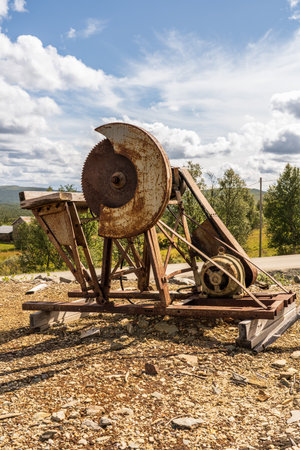 This large metal electric industrial circular saw, stands at the historic Gustav copper mine in RÃ¸ros, Norway, showcasing its engineering heritage.の写真素材