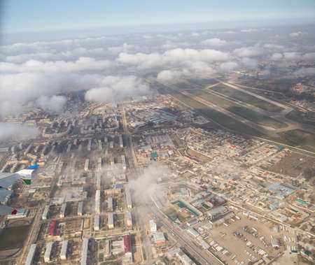 Clouds mountains and sky as seen through window of an aircraft of uzbekistanの写真素材