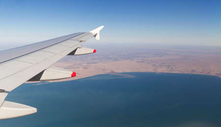 Clouds mountains and sky as seen through window of an aircraft of uzbekistanの写真素材