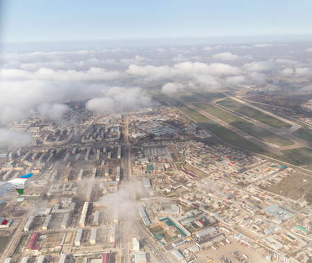 Clouds mountains and sky as seen through window of an aircraft of uzbekistanの写真素材