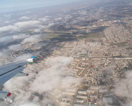 Clouds mountains and sky as seen through window of an aircraft of uzbekistanの写真素材