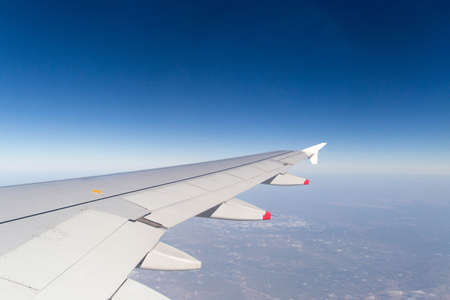 Clouds mountains and sky as seen through window of an aircraft of uzbekistanの写真素材