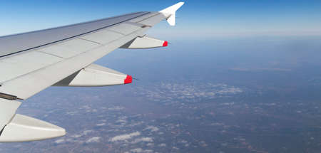 Clouds mountains and sky as seen through window of an aircraft of uzbekistanの写真素材