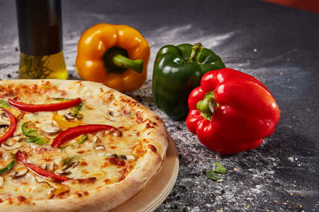 Red green yellow pepper in the kitchen black beautiful backgroundの写真素材