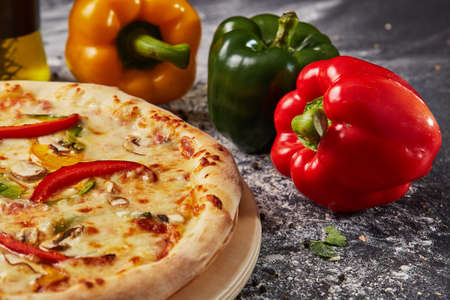 Red green yellow pepper in the kitchen black beautiful backgroundの写真素材