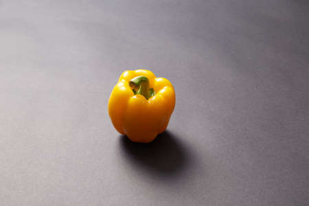 Red green yellow pepper in the kitchen black beautiful backgroundの写真素材