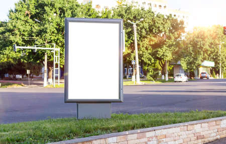 Blank white mock up of vertical light box in a bus stop in beautiful weatherの写真素材
