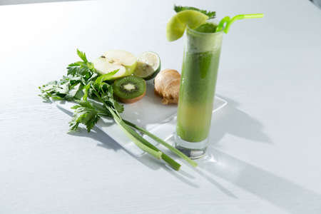 Healthy and fresh kiwi smoothie in glass on isolated white backhroundの写真素材