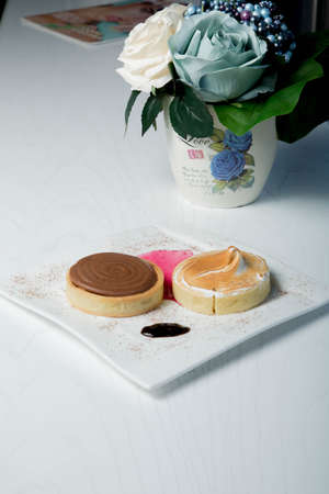 Delicious little cakes with strawberries and cocolate in white woodの写真素材