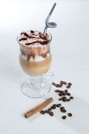 Glass of cold latte coffee topic cocolate cream on isolated white background with dessertsの写真素材