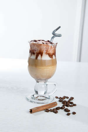 Glass of cold latte coffee topic cocolate cream on isolated white background with dessertsの写真素材