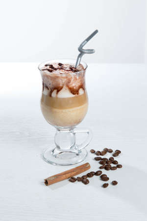 Glass of cold latte coffee topic cocolate cream on isolated white background with bananaの写真素材
