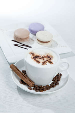 Ice coffee and coffee and nuts near desserts and macaroons in white backgroundの写真素材