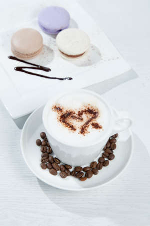 Ice coffee and coffee and nuts near desserts and macaroons in white backgroundの写真素材