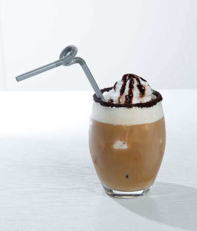 Ice coffee and coffee and nuts near desserts and macaroons in white backgroundの写真素材
