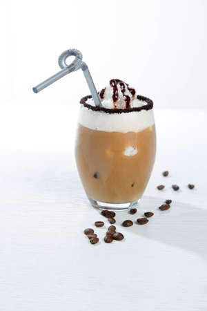 Ice coffee and coffee and nuts near desserts and macaroons in white backgroundの写真素材