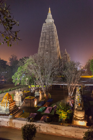 The place of an enlightenment of Buddha, Mahabodhi Temple in beams of night illumination and in festive decoration in honor of a menlam and celebration of Buddhist new year.の写真素材