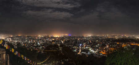 Panoramic view from Svayambunath stupa point of view on the infinite city of Kathmandu in drama night-time lighting.の写真素材