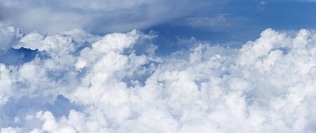 Panoramic view of the massif of the cumulus clouds like a mountains, at the height of 10000 meters (about 6 miles) symbolizing purity and a heavenly dwelling place.の写真素材