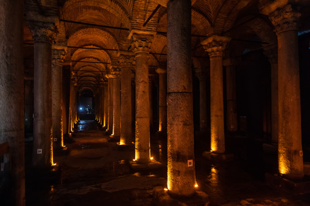 The high arches and set of columns of an underground reservoir of the ancient city of Constantinople known to us as the Cisterna Basilica, in beams of decorative illumination.の写真素材