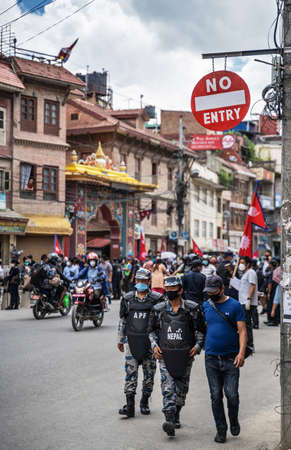 June 14, 2020, Kathmandu, Nepal. AFP Special Forces police walking under sign "No entry", along a street full of demonstrators protesting corruption and ineffective fight against coronavirus in Nepal.のeditorial素材
