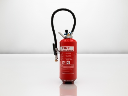 Extinguisher on white and glossy surfaceの写真素材