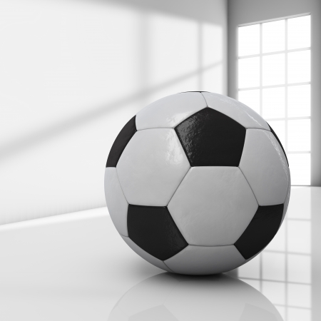Football on a room with bright light coming from a windowの写真素材