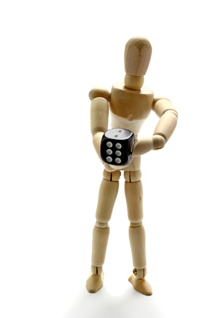 Wooden manikin holding diceの写真素材