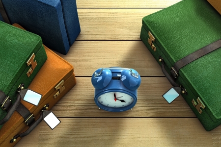 Three suitcases and a clock on a tableの写真素材