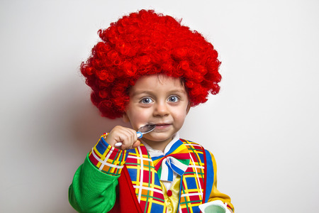 Funny Child wearing a clown suitの写真素材