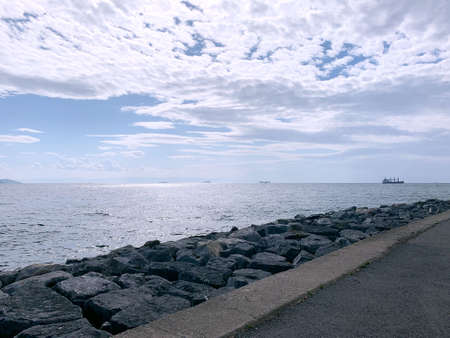 Stone seashore under the blue skyの写真素材