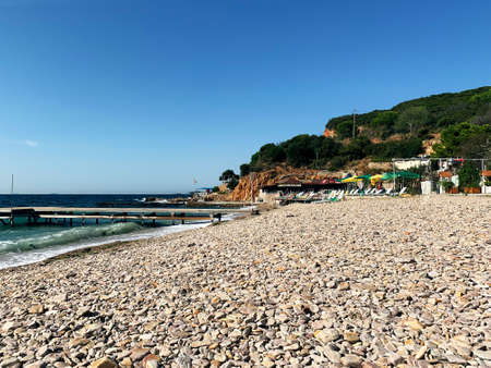 Stone coast of the blue sea with wavesの写真素材