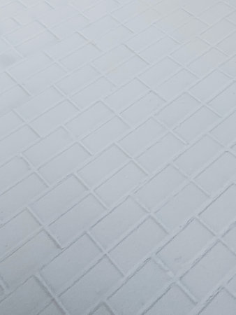 The path of tiles is covered with snow. Abstract background of white tiles. High quality photoの写真素材