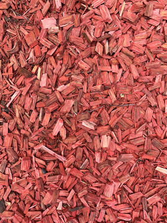 Close-up of Red wood Chips backdrop. Natural Mulch background for garden design and eco-projects. Bark texture macro. Wooden Surface for packaging. Landscape design for site decoration. Vertical photoの写真素材