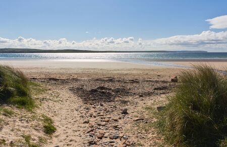 Dunnet Bay is a sand and shingle rural beach backed by some grass covered dunes.This photo shows a panorama view on the beachの写真素材