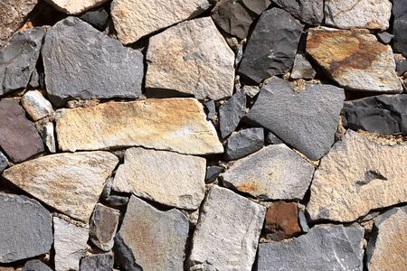 Texture of the yellow granite stone wall for background