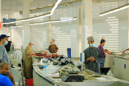 March 16 2022 - Muscat, Oman: Mutrah fish market of Muscat. Men get all hard working in the Islamic countryのeditorial素材