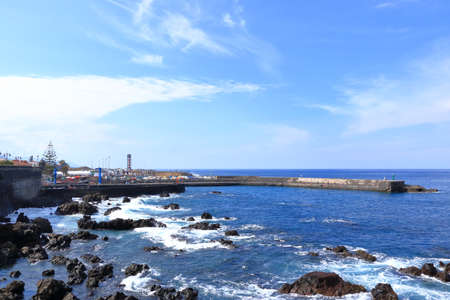 November 20 2021 - Puerto de la Cruz, Tenerife, Canaries: harbor and coastline in the sunのeditorial素材