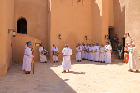 March 17 2022 - Nizwa, Oman: Omani men dancing a traditional sword dance at the Nizwa Fort