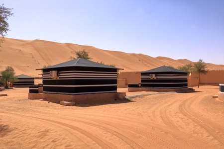 Bedouin style camping beside a huge sand dune at the Wahiba Sands desert in Oman.の写真素材
