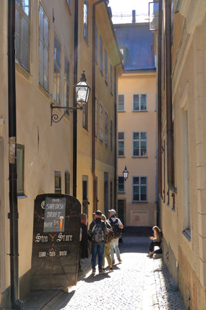 May 24 2022 - Stockholm in Sweden: Tourists walking on cobble streets in Riddarholmen is part of Gamla stan is old town of the city, Swedenのeditorial素材