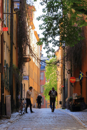 May 24 2022 - Stockholm in Sweden: Tourists walking on cobble streets in Riddarholmen is part of Gamla stan is old town of the city, Swedenのeditorial素材