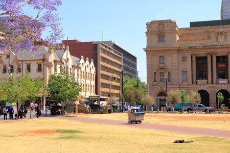 September 29 2022 - Pretoria in South Africa: Church Square, People during the day, walking or resting on the grass in the center of the Cityのeditorial素材